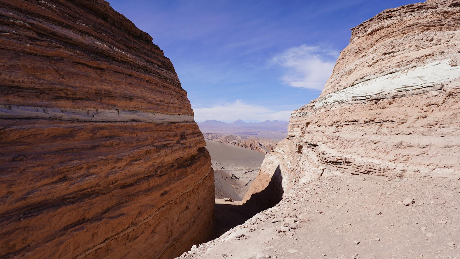 Explore the breathtaking sandstone formations in San Pedro de Atacama under a clear blue sky.