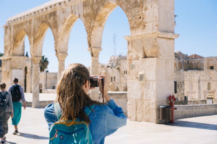 Woman Taking Pictures Of Ruins