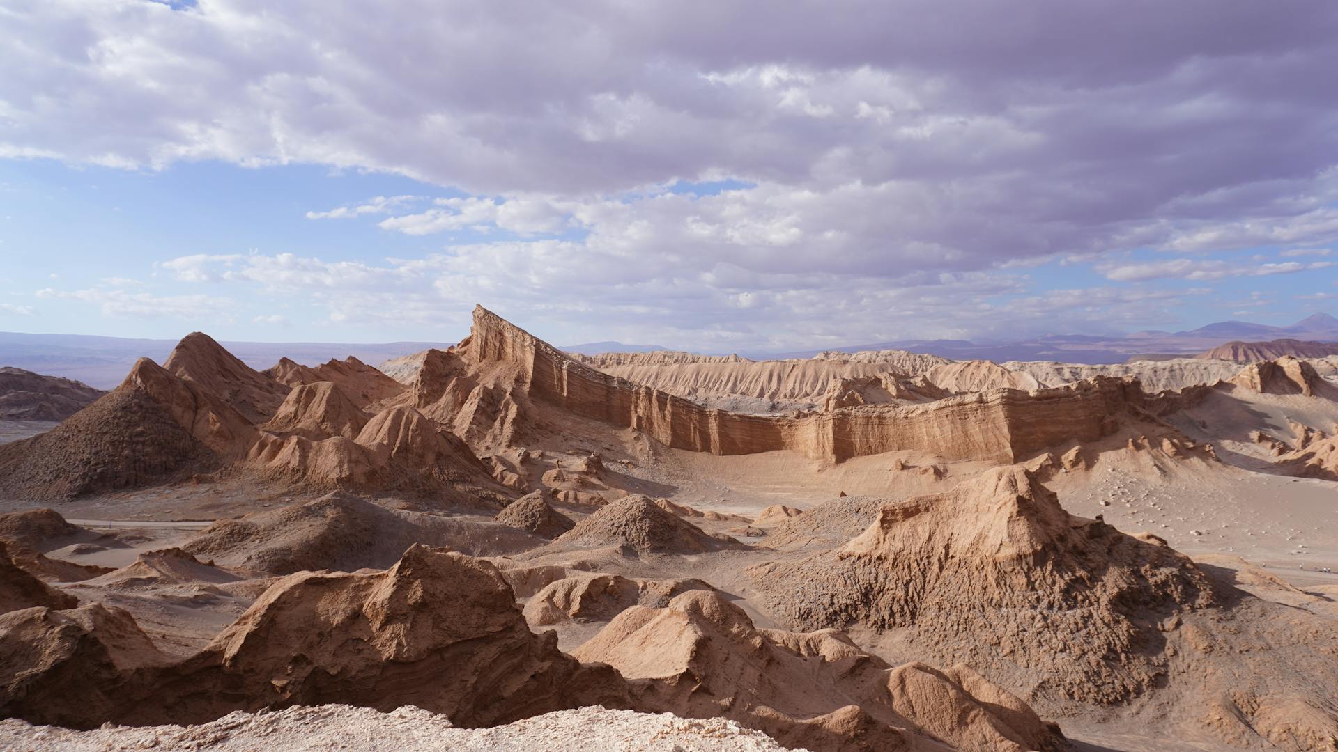 Stunning view of desert rock formations under a vast sky in San Pedro de Atacama.