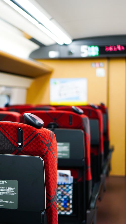 A train with red seats and a black sign