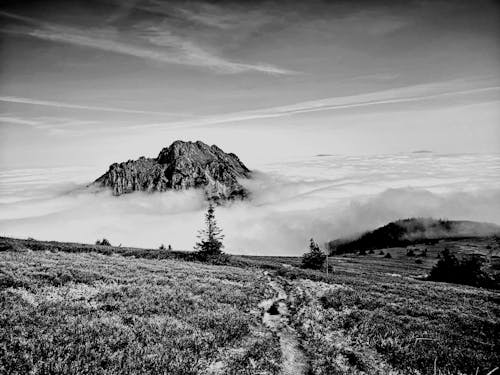 Black and white photo of a mountain in the clouds