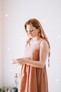 Woman in a flowing boho sundress standing indoors, beautifully illuminated.
