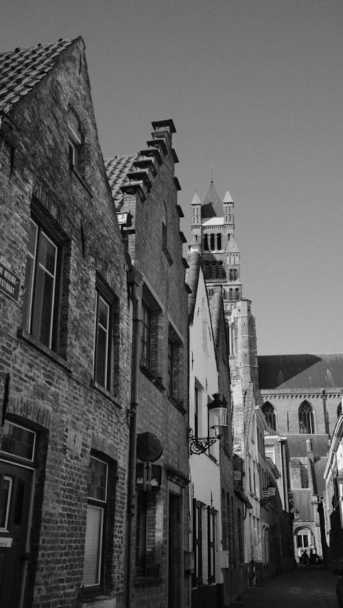 A black and white photo of a street with buildings