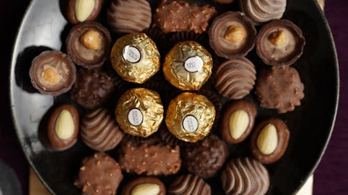 A plate of chocolates with nuts and candies