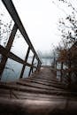 A wooden bridge over a lake in the fog