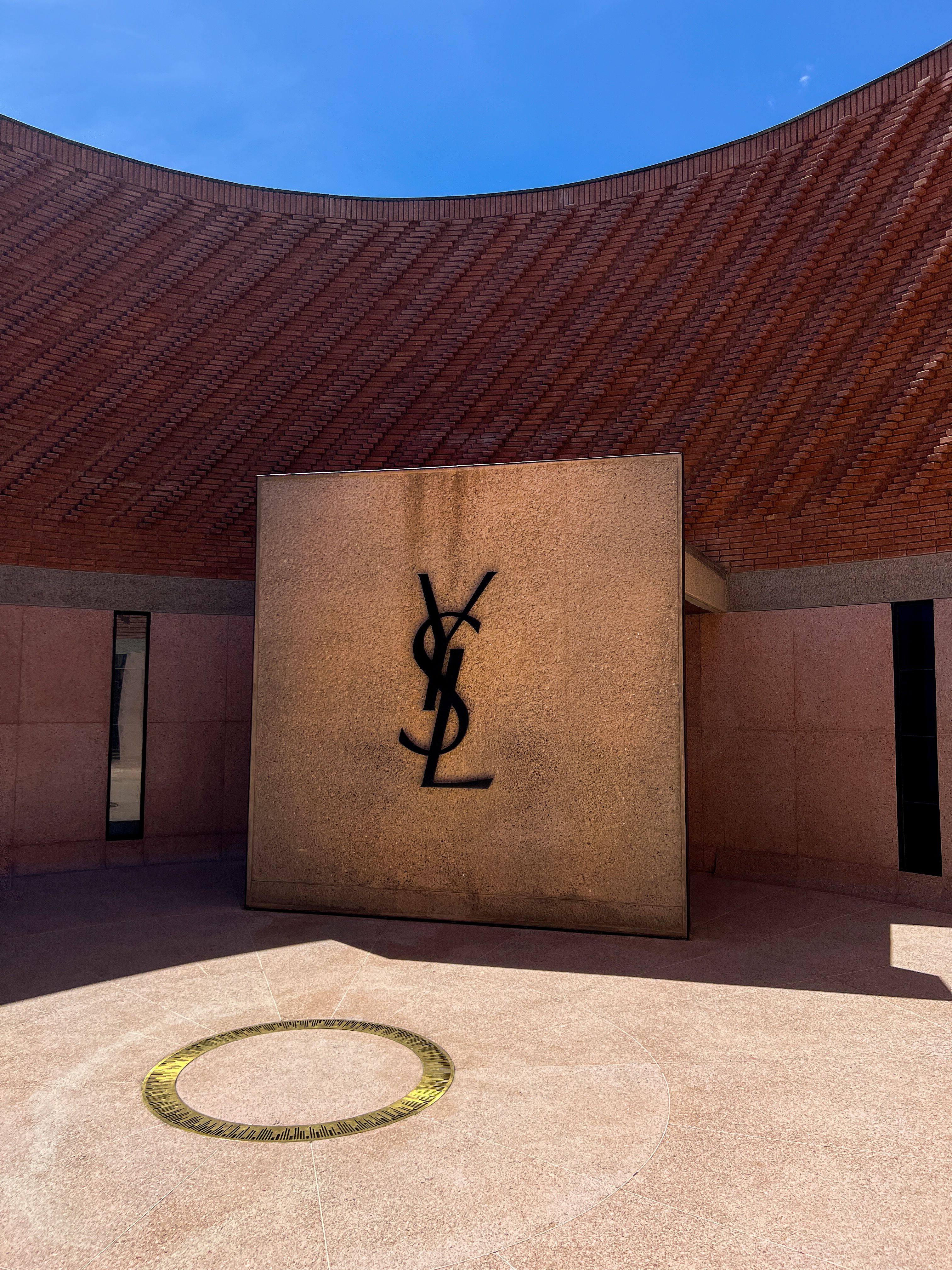 Yves Saint Laurent Logo on Wall · Free Stock Photo