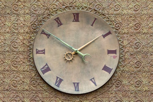 A clock on a wall with roman numerals