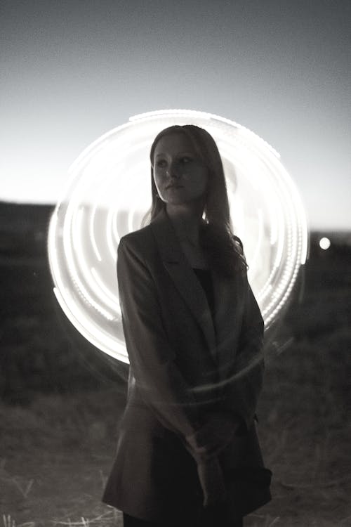 A woman standing in front of a light ring