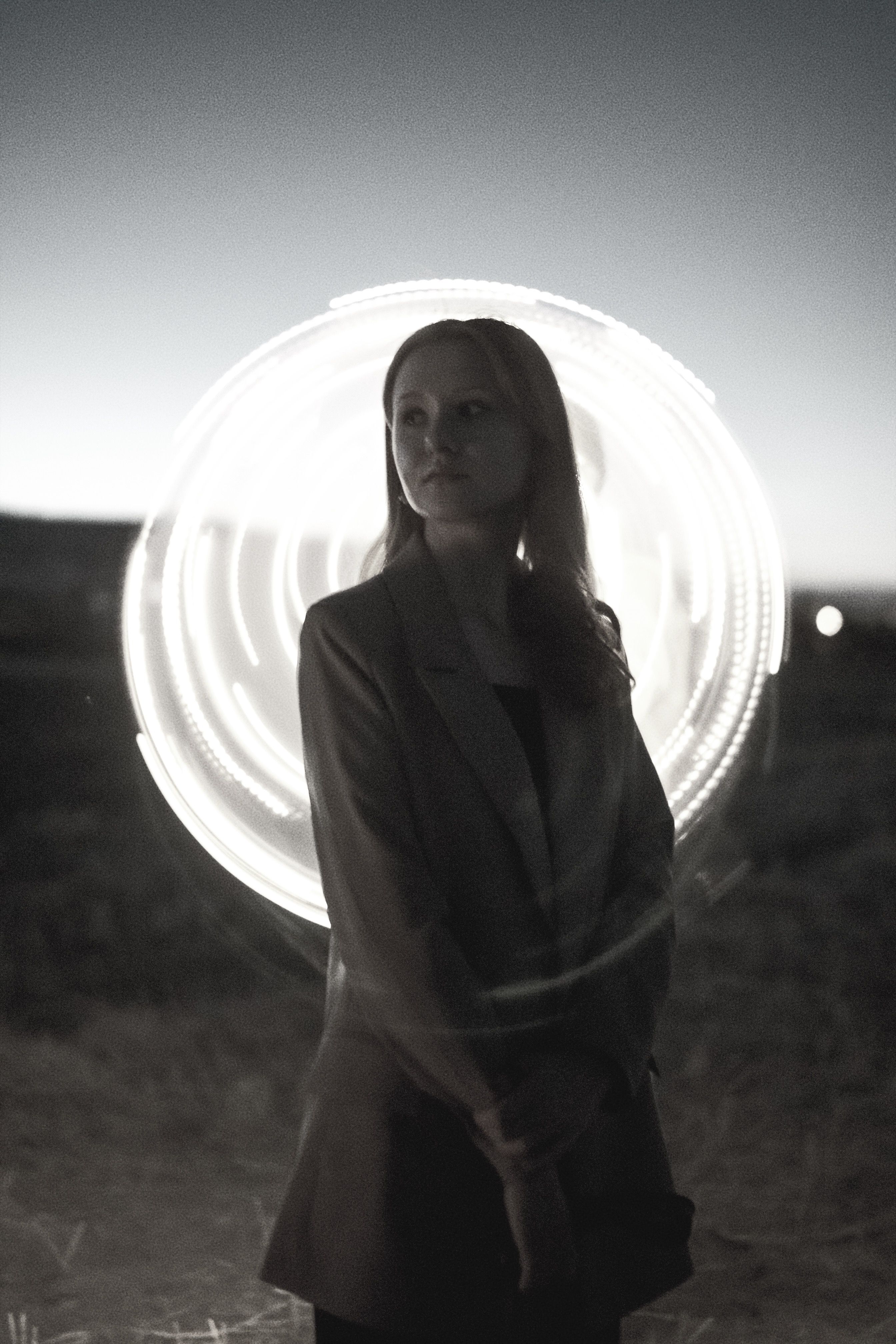 Woman in Front of a Light in Black and White · Free Stock Photo