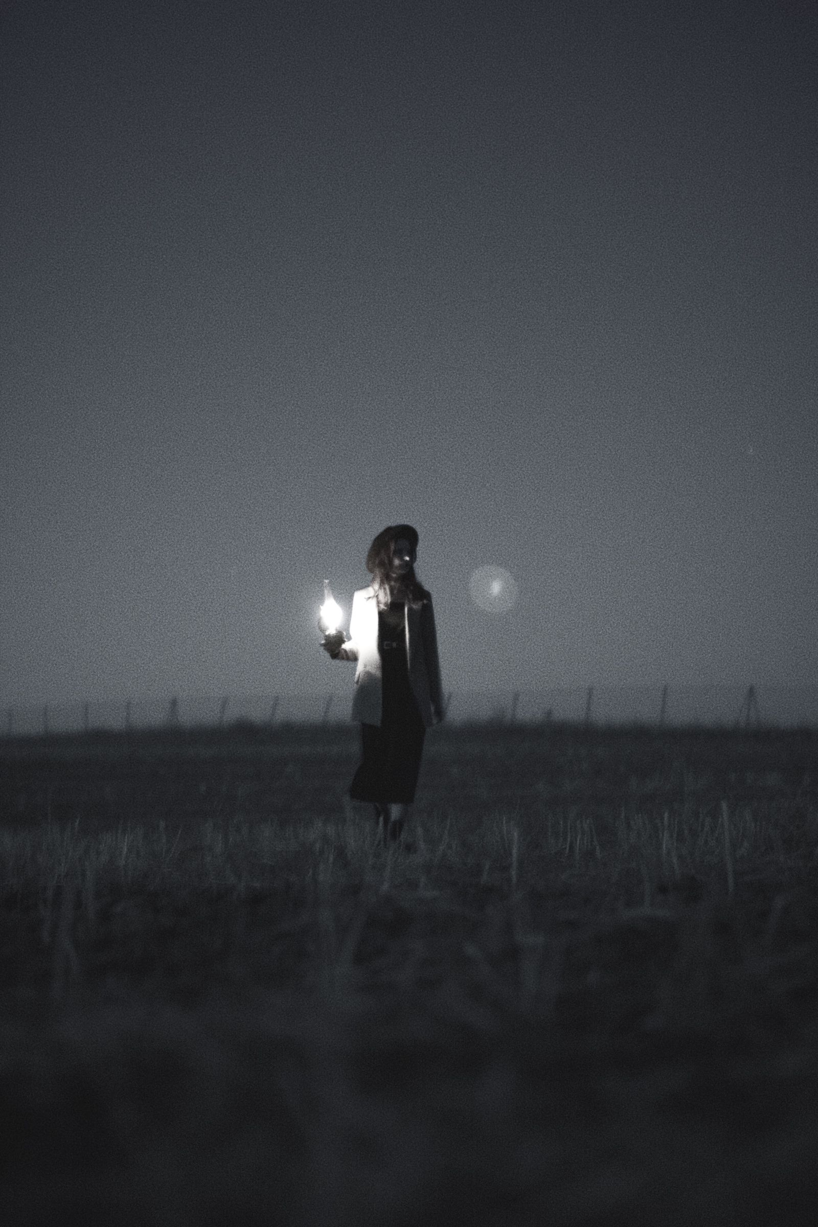 Black and White Silhouette of a Woman Holding a Lantern · Free Stock Photo