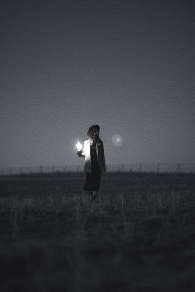 Black and White Silhouette of a Woman Holding a Lantern · Free Stock Photo
