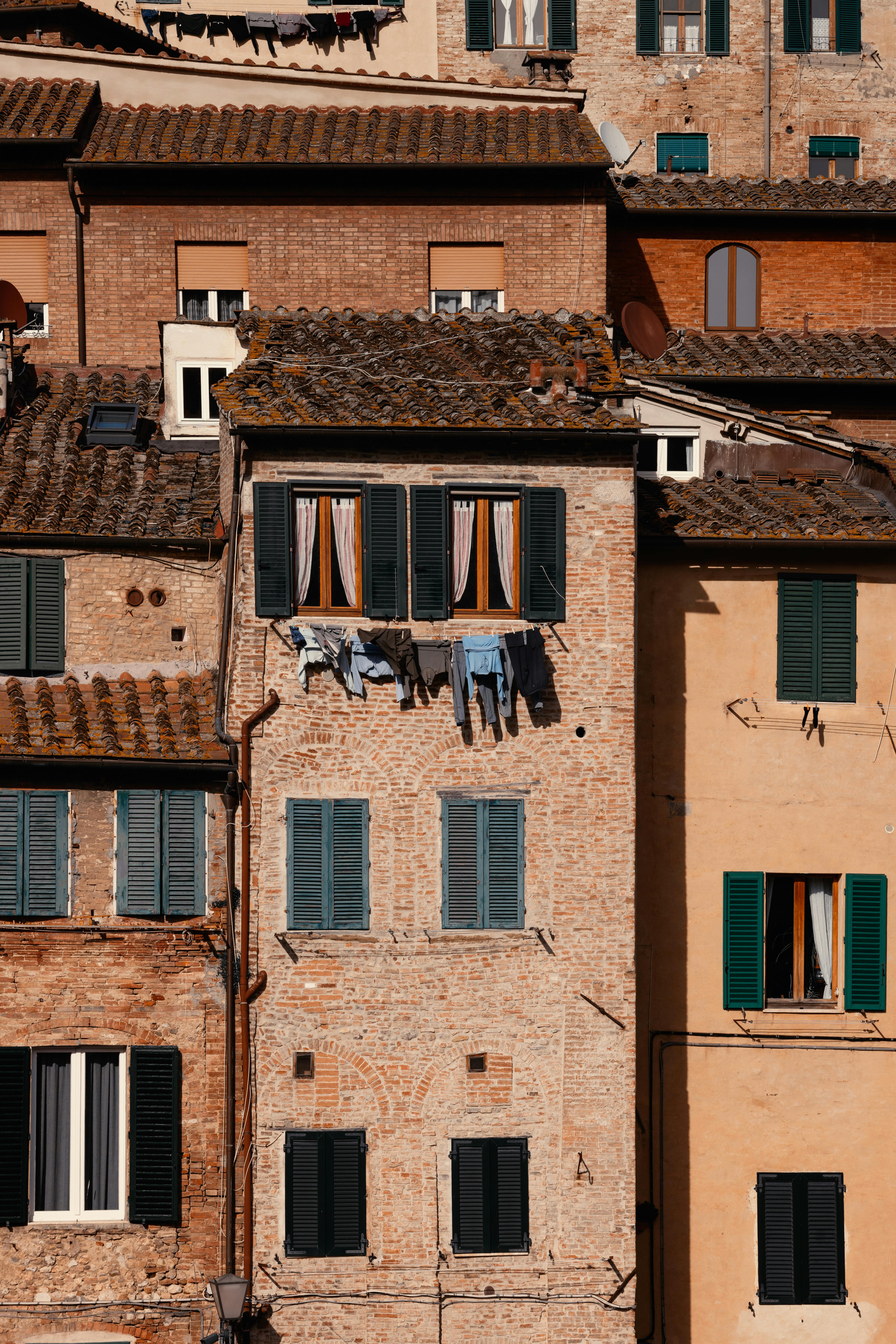 Traditional brick buildings with laundry hanging in an old European city.