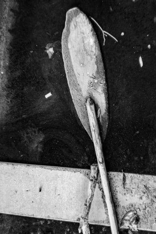 A black and white photo of a wooden paddle