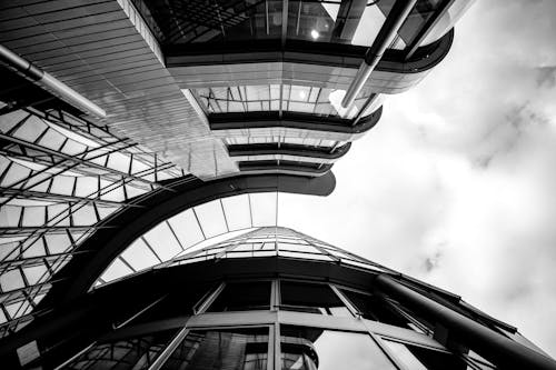 Black and white photo of a building with glass