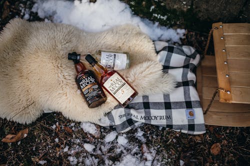 A bottle of whiskey and a bottle of whiskey on a blanket