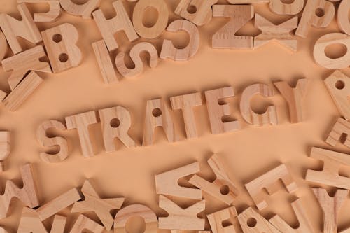 The word strategy surrounded by wooden letters