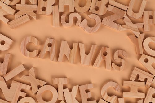 The word canvas surrounded by wooden letters