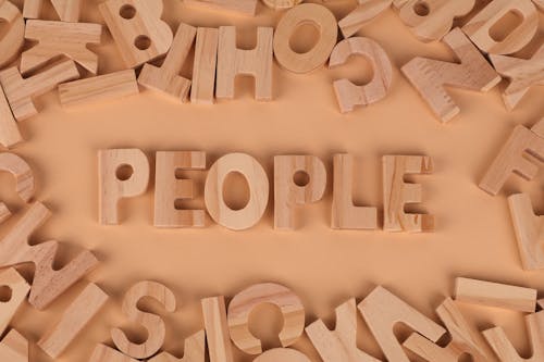 The word people surrounded by wooden letters