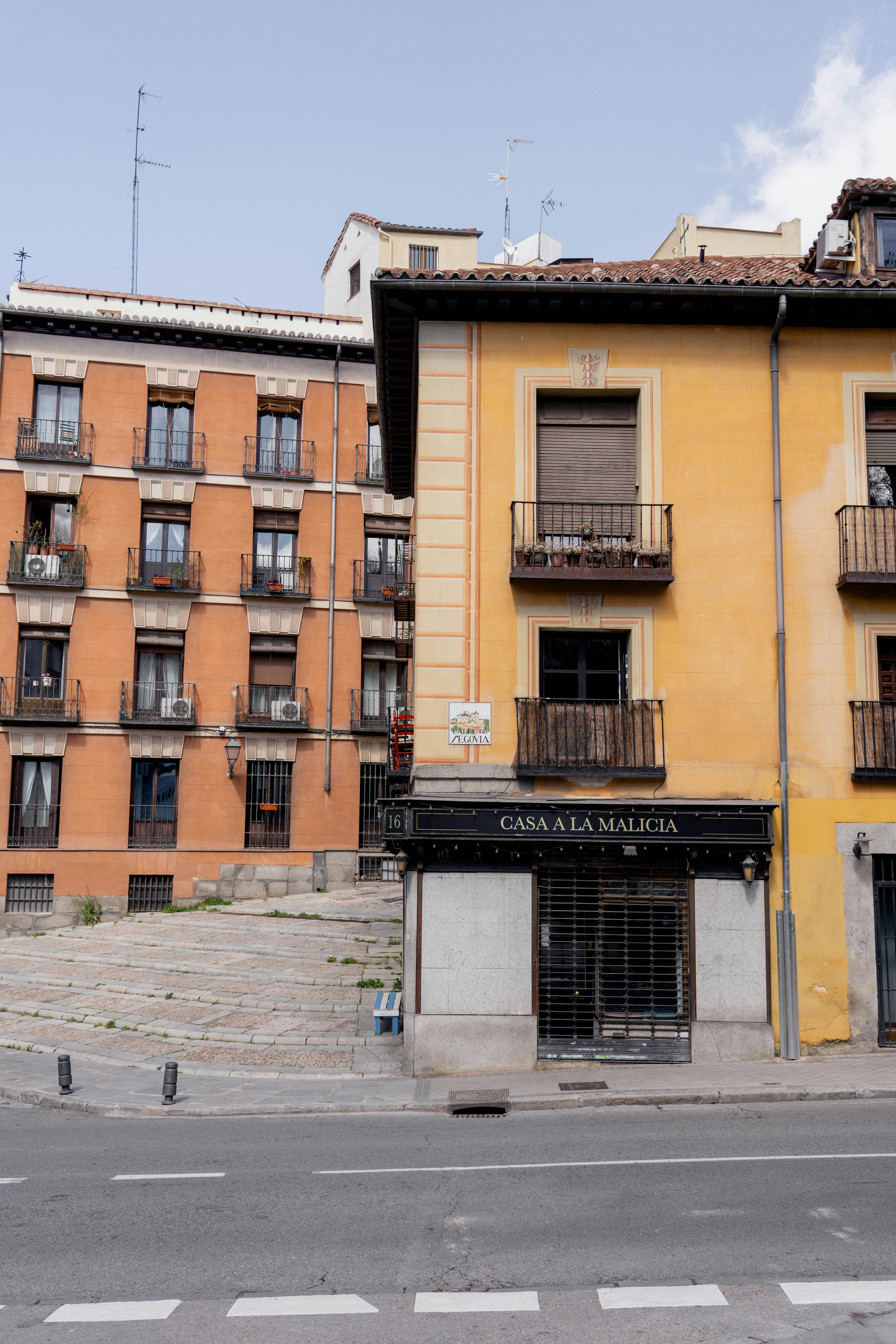 Colorful historical buildings in Madrid showcase classic urban architecture on a sunny day.