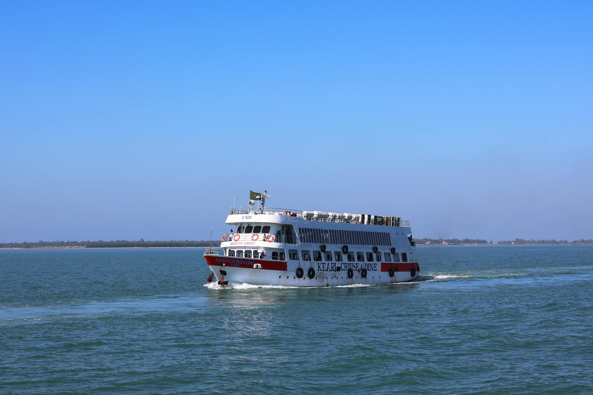 Cruise ship navigating the waters of Cox's Bazar, Bangladesh on a clear day.