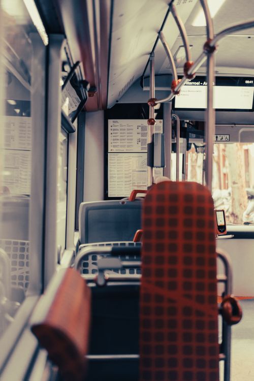 Free Empty city bus interior with seats and windows in view, offering a modern public transport concept. Stock Photo