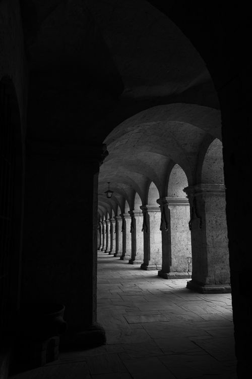 Free Black and white view of historic monastery arches in Arequipa, Peru, highlighting architectural beauty and shadow play. Stock Photo
