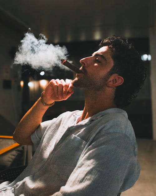 A man smoking a cigar in a chair