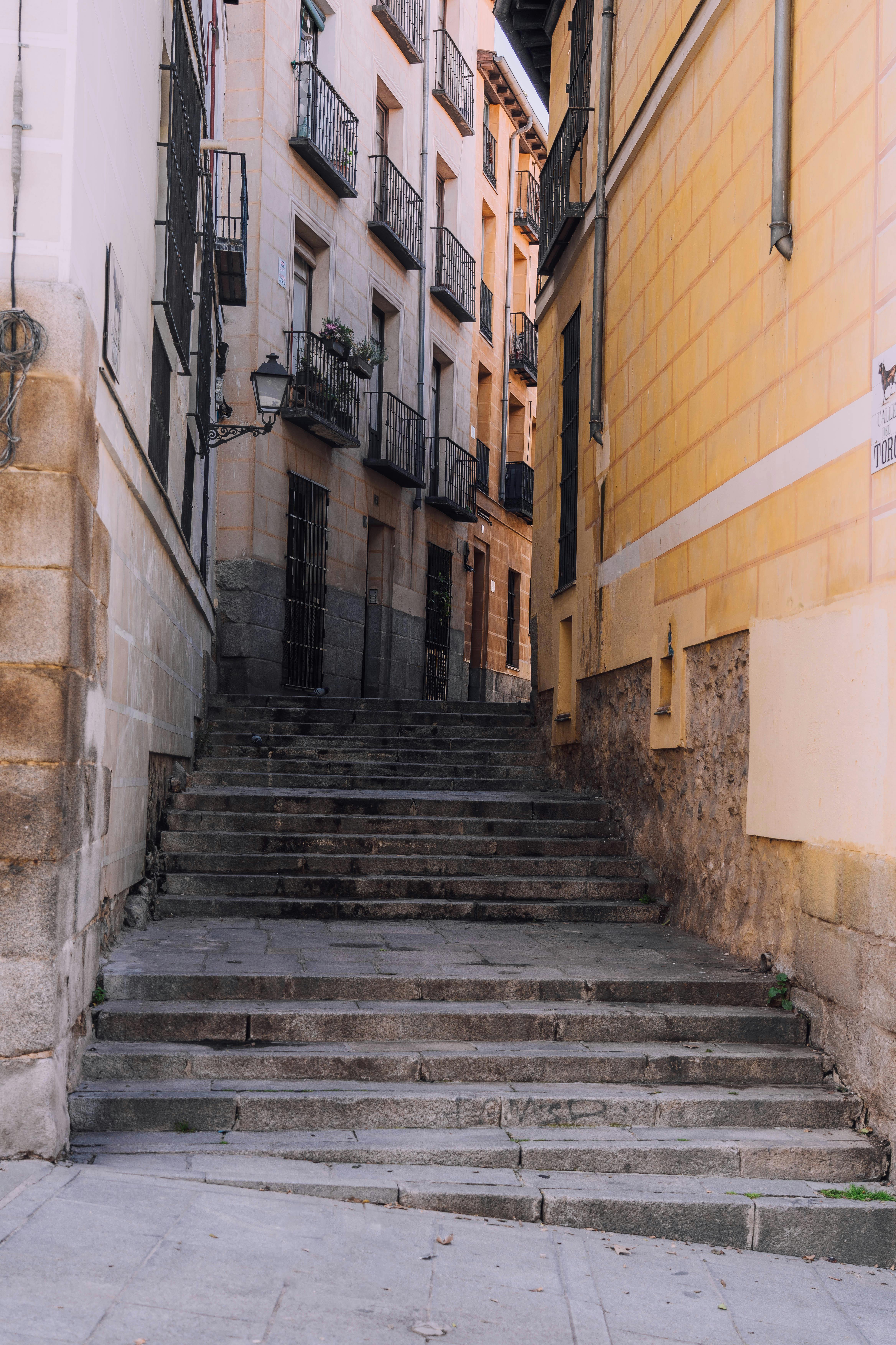 A picturesque alley with stone steps and historic architecture in Madrid.