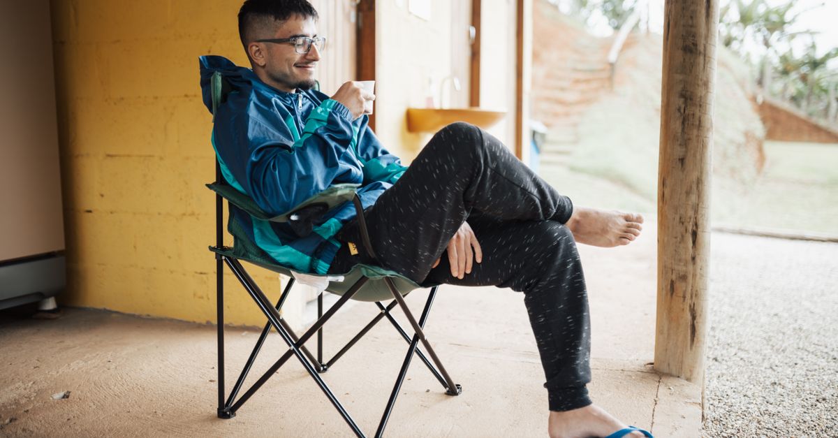 person sitting on porch at sunrise with coffee, no phone visible, peaceful morning scene