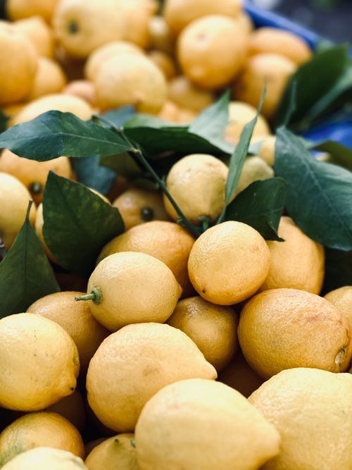 Free A collection of ripe lemons with fresh green leaves, showcasing natural beauty and citrus freshness. Stock Photo