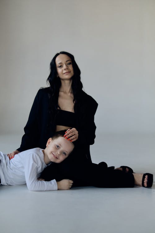 A woman and a child sitting on the floor
