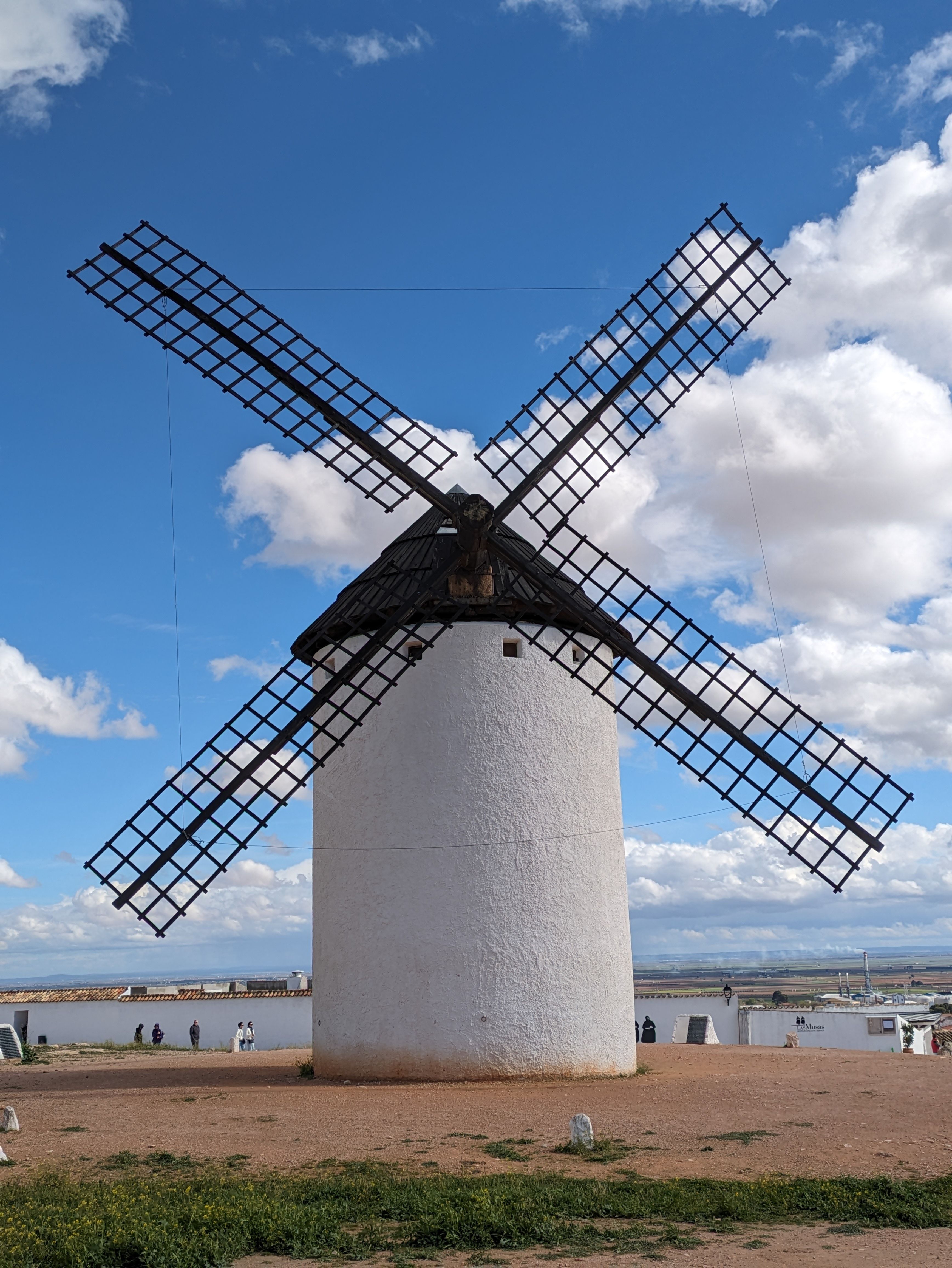 Majestic windmill against a blue sky in Campo de Criptana, showcasing Spanish heritage.