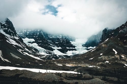 Free Stunning mountain scene with rugged peaks and cloudy sky in Jasper, Alberta, Canada. Stock Photo