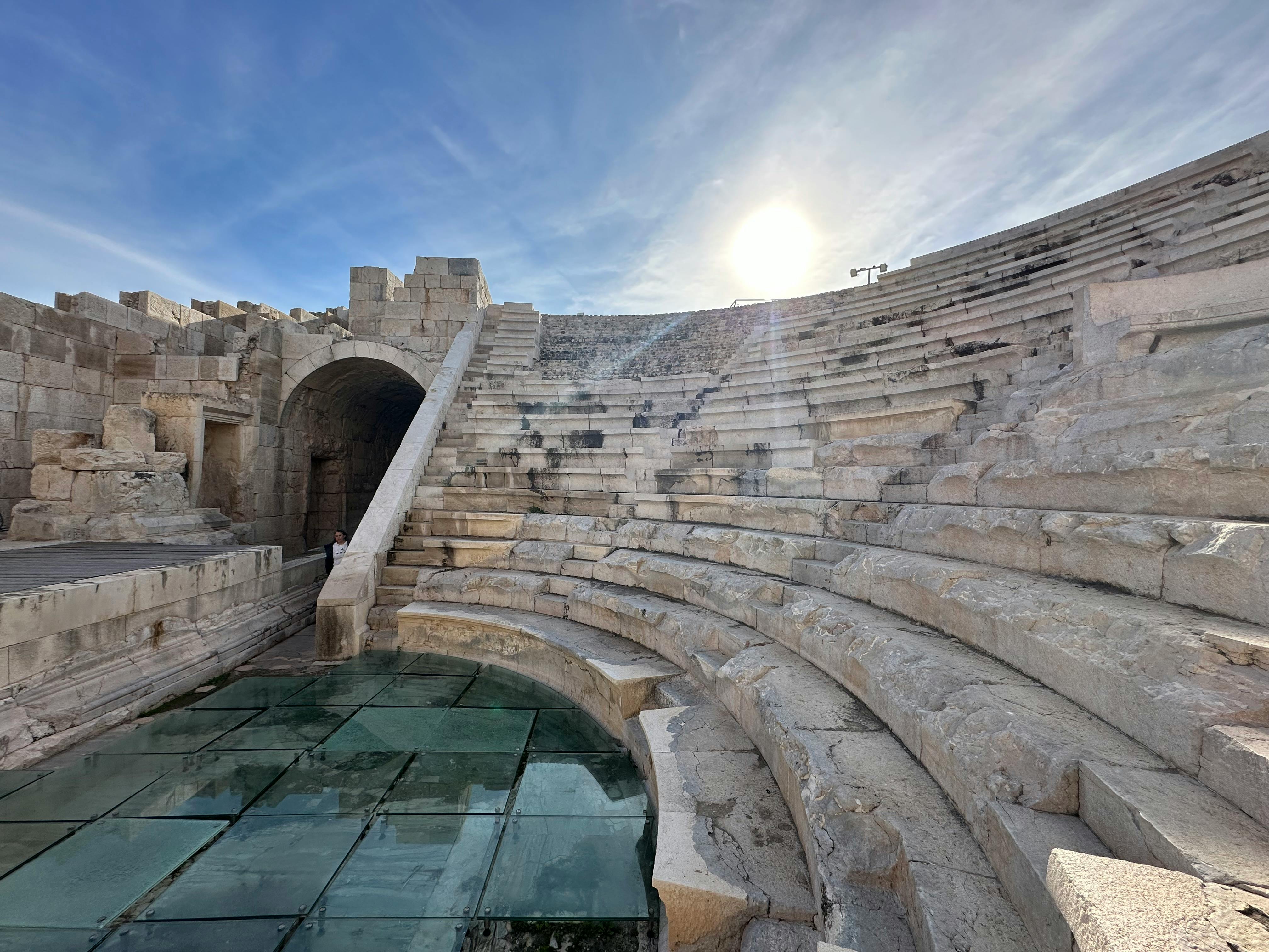 Free Explore the historic stone structure of a Roman amphitheater under a bright daytime sky. Stock Photo