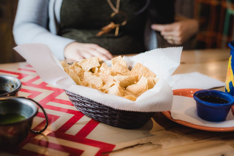 Close-Up Photo Of Chips On Wicker Bowl