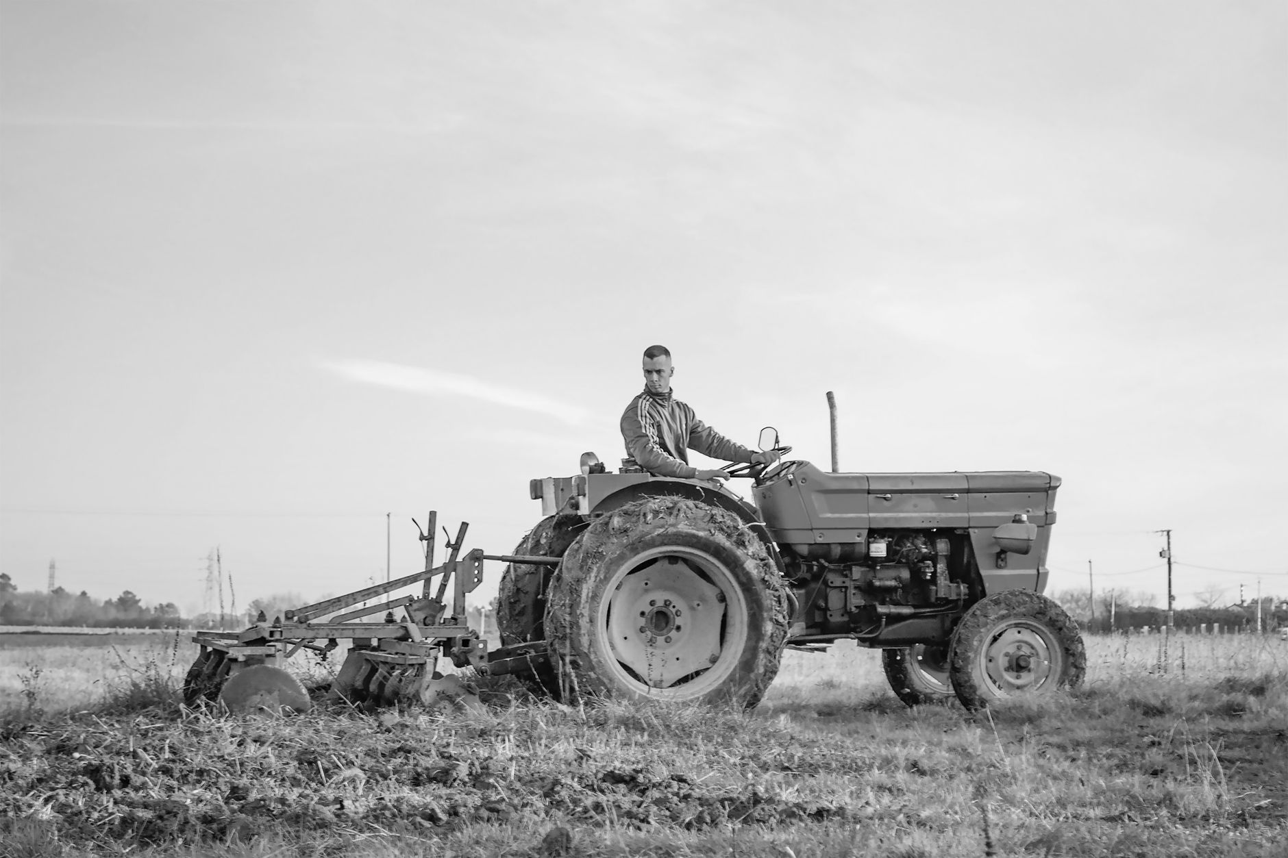 A farmer using a tractor to plow a field in Parcoul-Chenaud, France.
