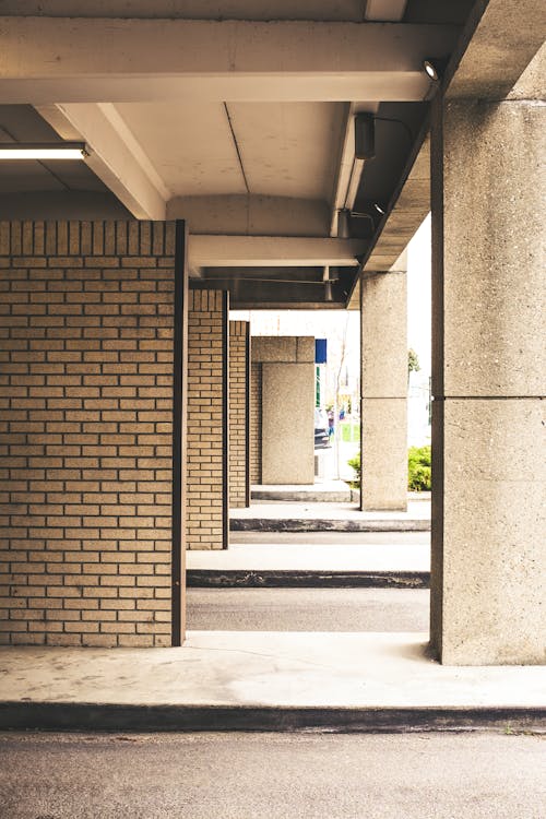 A photo of a parking lot with a brick wall