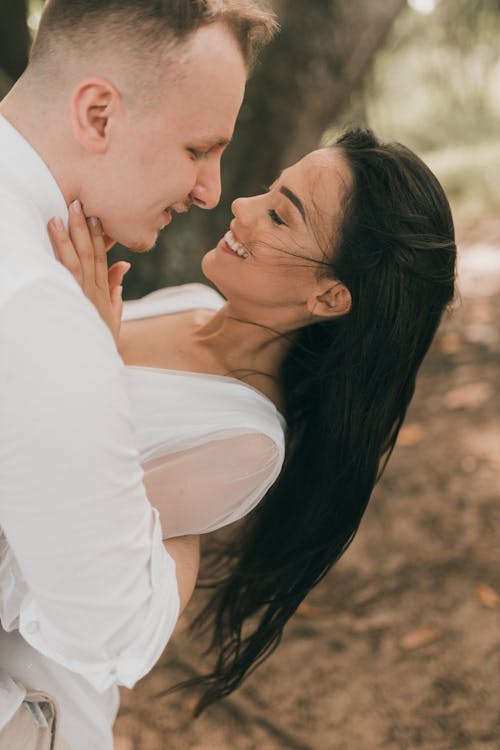 A couple embracing in the woods during their wedding