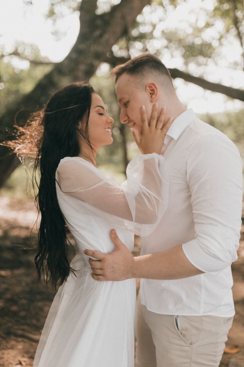 Free A romantic moment captured between an embracing couple outdoors during the day. Stock Photo