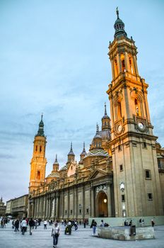 Stunning architecture of the Basilica de Nuestra Señora del Pilar in Zaragoza, Spain with evening crowd.
