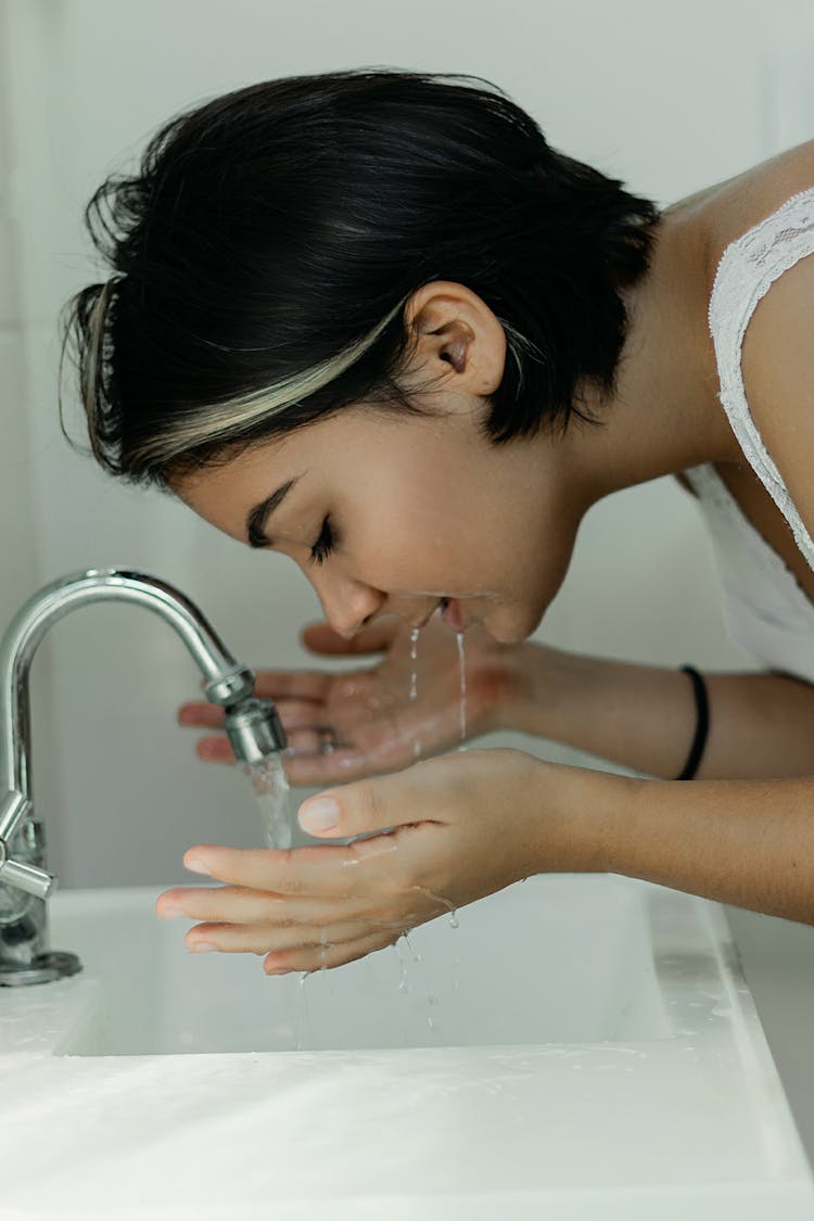 Woman Washing Her Face With Water