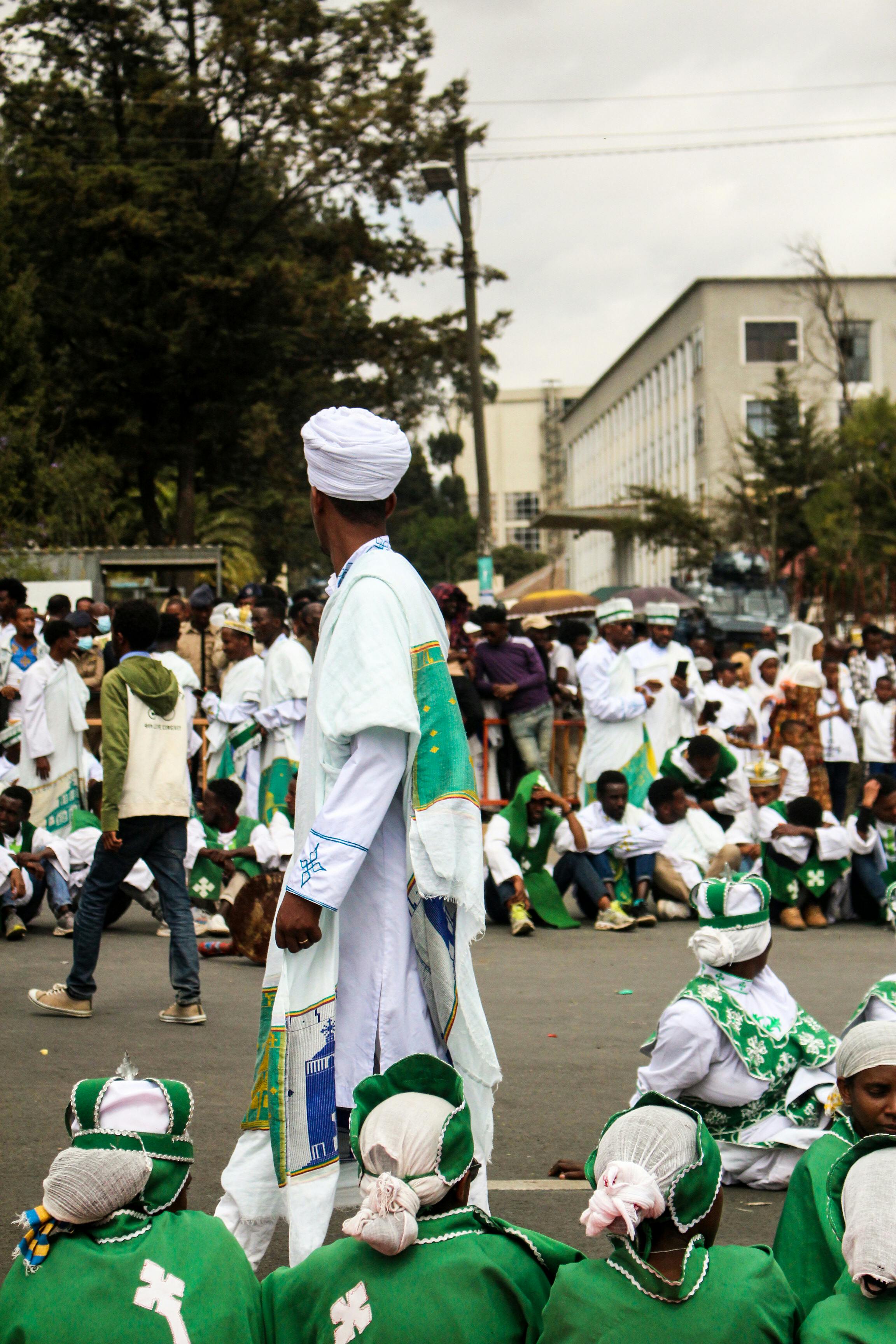 Traditional Ethiopian festival with people in colorful attire gathered outdoors in Addis Ababa.