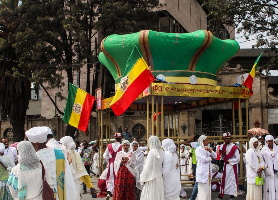 Colorful traditional parade in Addis Ababa, Ethiopia showcasing cultural attire and flags.