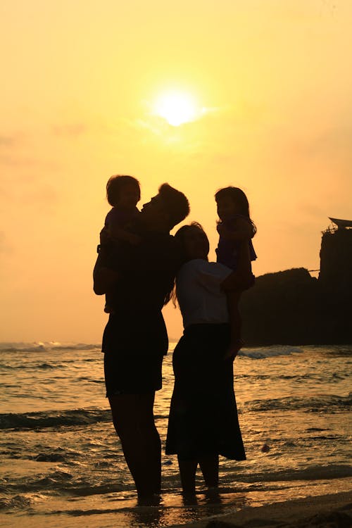 Family with Children on Beach at Sunset