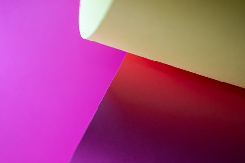 Free Vibrant abstract image featuring a gradient of colorful paper surfaces for creative design use. Stock Photo