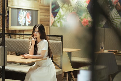 A woman sitting at a table in a restaurant