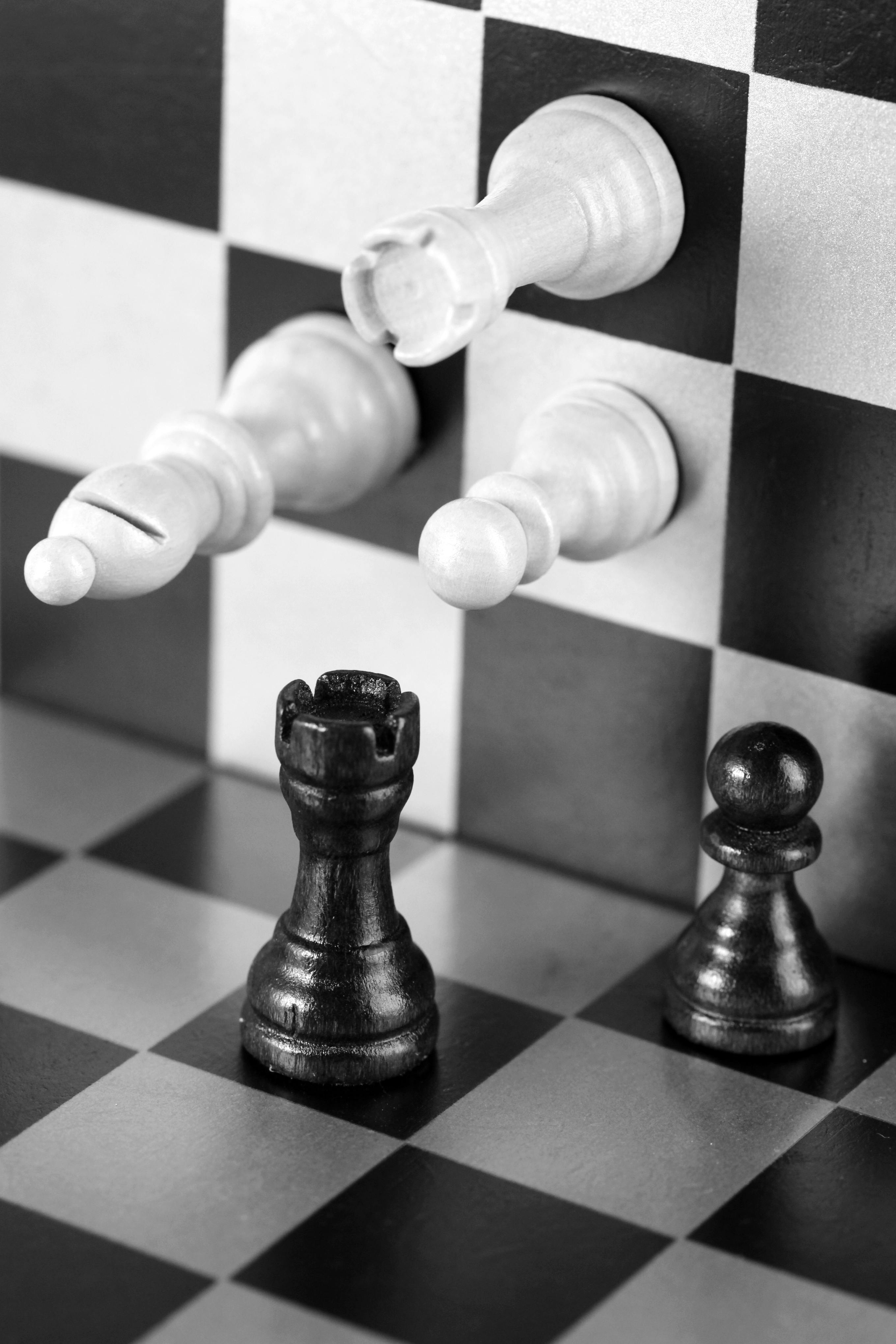 pawns bishop and a rook on a checkerboard in black and white