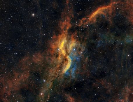 Dynamic scene of colorful gas clouds and stars in a cosmic nebula.