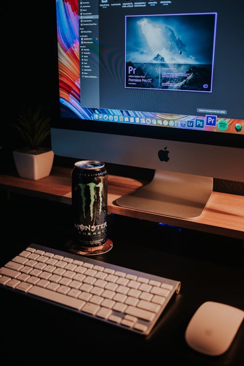 Computer and a Can of Drink on a Desk 