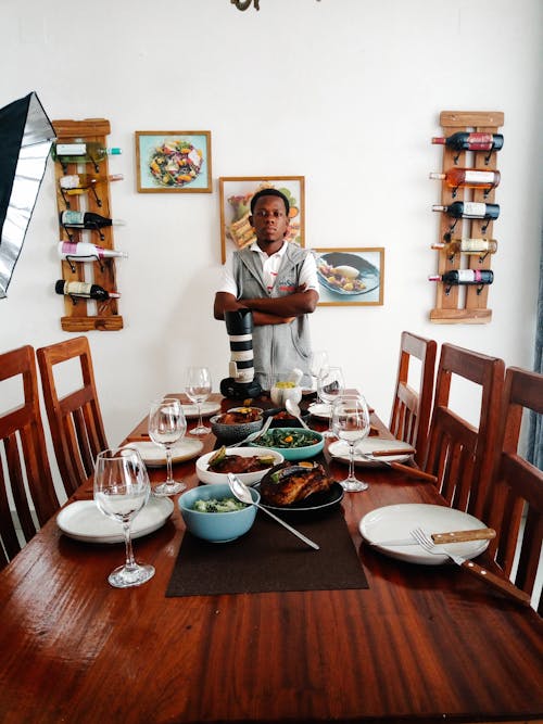 A man standing in front of a dining table